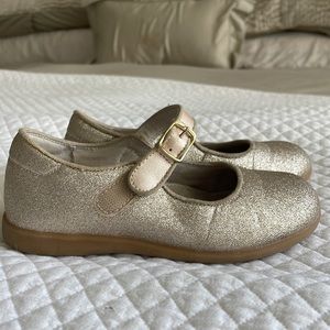 Sparkly gold girls L’Amour Mary Jane shoes.